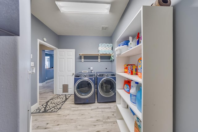 17611 Wind Mist Ln, Cypress, TX 77433 - washroom with wood finished floors and washing machine and clothes dryer