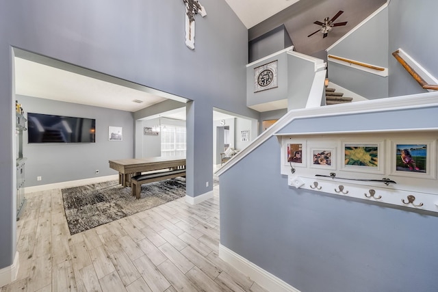 17611 Wind Mist Ln, Cypress, TX 77433 - entrance foyer with wood finished floors, stairs, ceiling fan, baseboards, and a high ceiling