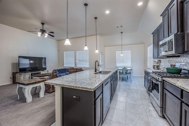 214 San Bernard Dr, Baytown, TX 77523 - kitchen featuring stainless steel appliances, a sink, tasteful backsplash, baseboards, and lofted ceiling