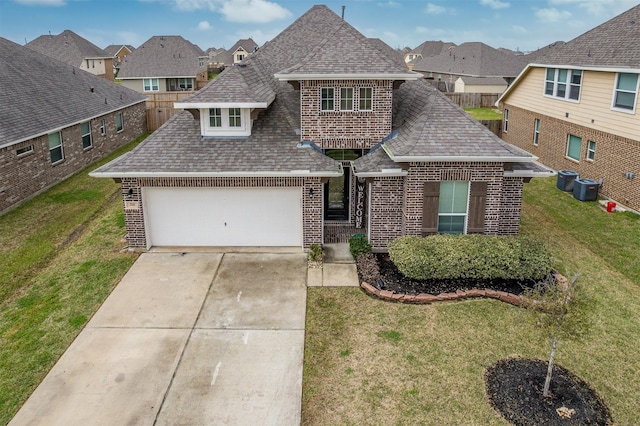 214 San Bernard Dr, Baytown, TX 77523 - view of front of property with brick siding, roof with shingles, driveway, an attached garage, and a residential view