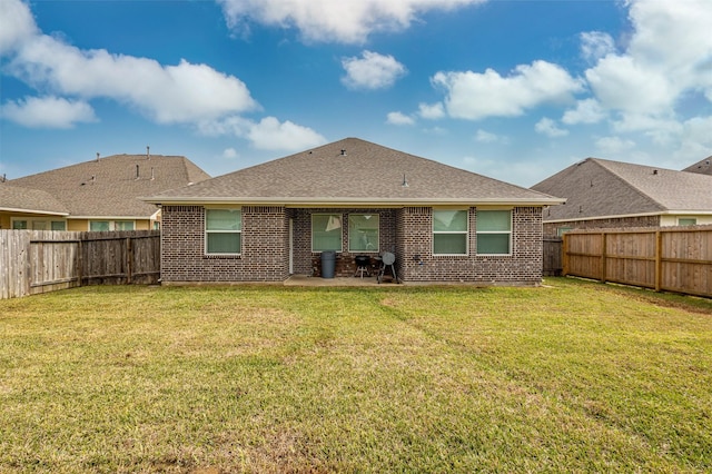 214 San Bernard Dr, Baytown, TX 77523 - rear view of house with brick siding, a patio, and roof with shingles