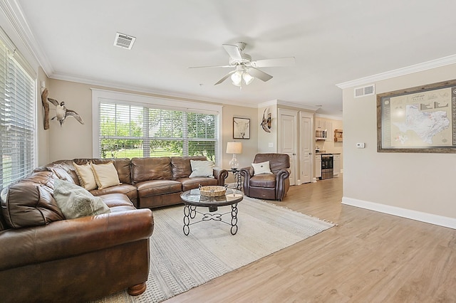 1725 Harvey Mitchell Pkwy S Unit 211, College Station, TX 77840 - living area with crown molding, a ceiling fan, light wood-style flooring, and baseboards