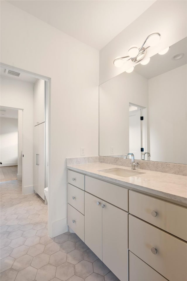 966 Lamonte Ln, Houston, TX 77018 - bathroom featuring vanity, toilet, tile patterned flooring, and baseboards