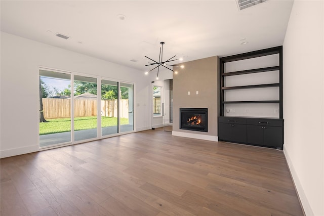 966 Lamonte Ln, Houston, TX 77018 - unfurnished living room with baseboards, a chandelier, wood finished floors, and a fireplace