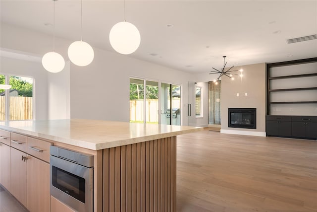 966 Lamonte Ln, Houston, TX 77018 - kitchen with healthy amount of natural light, light wood-style floors, a chandelier, and light countertops