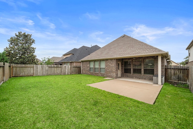 back of house featuring brick siding, a patio, and a shingled roof