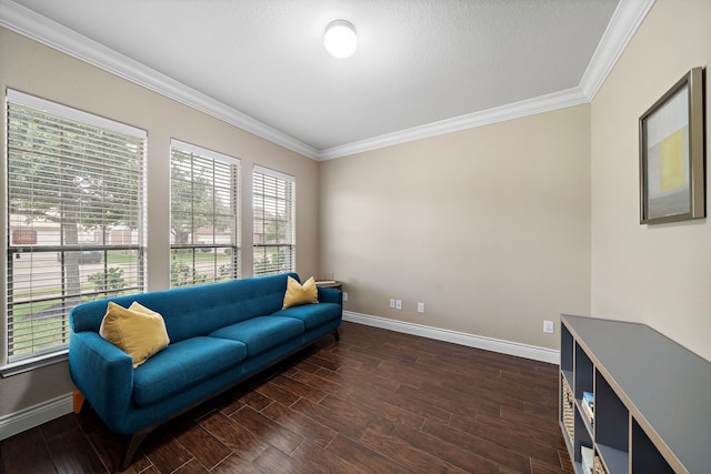 sitting room featuring ornamental molding, baseboards, and dark wood finished floors