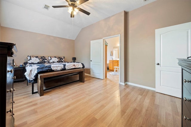 bedroom with light wood-style flooring, ceiling fan, vaulted ceiling, ensuite bathroom, and baseboards