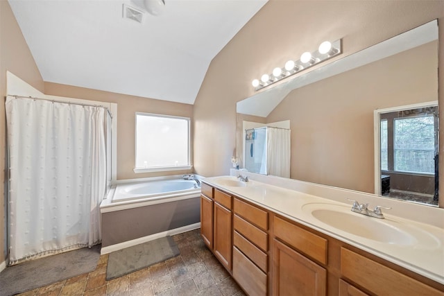 full bath with lofted ceiling, a garden tub, double vanity, stone finish floors, and curtained shower