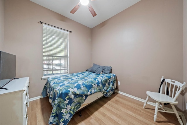 bedroom featuring wood finished floors, baseboards, ceiling fan, and lofted ceiling