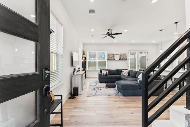 living area featuring light wood-style floors, stairs, ceiling fan, recessed lighting, and baseboards