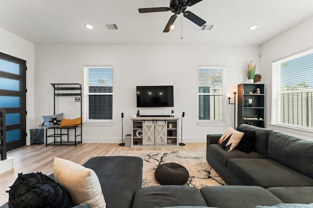 living room featuring plenty of natural light, ceiling fan, wood finished floors, recessed lighting, and baseboards