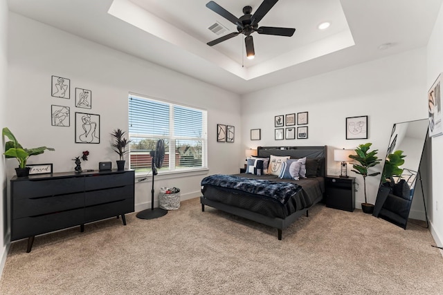 bedroom with light carpet, baseboards, a tray ceiling, ceiling fan, and recessed lighting