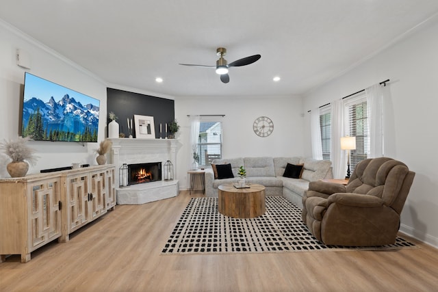2838 Sunburst Ln, Montgomery, TX 77356 - living area with light wood finished floors, a premium fireplace, ornamental molding, a ceiling fan, and recessed lighting