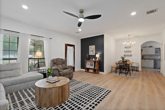 2838 Sunburst Ln, Montgomery, TX 77356 - living area featuring arched walkways, a ceiling fan, light wood-style floors, crown molding, and recessed lighting