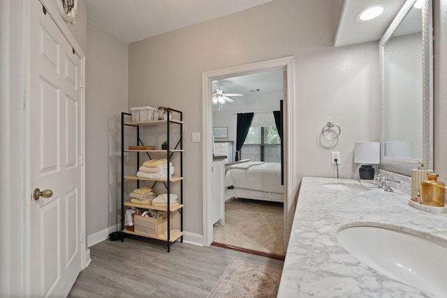 2838 Sunburst Ln, Montgomery, TX 77356 - ensuite bathroom featuring ceiling fan, wood finished floors, double vanity, and baseboards