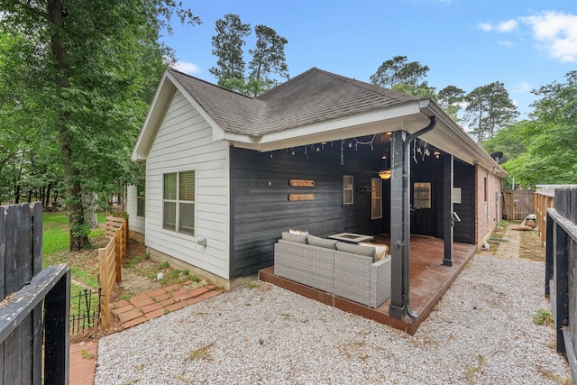 2838 Sunburst Ln, Montgomery, TX 77356 - view of side of property featuring a shingled roof, a fenced backyard, a patio, and outdoor lounge area