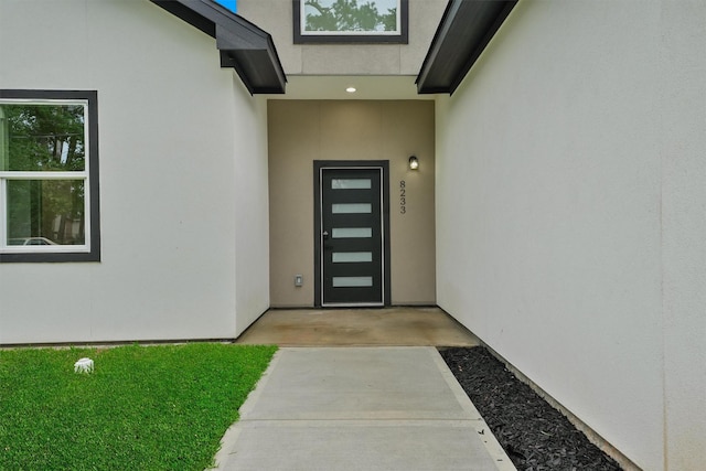 property entrance with stucco siding