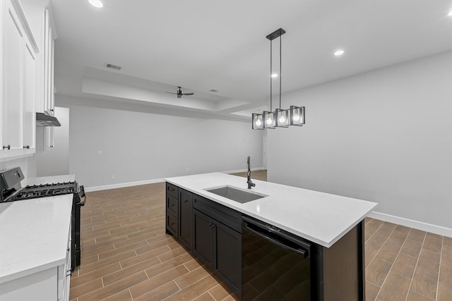 kitchen with dishwasher, a sink, gas range oven, baseboards, and recessed lighting