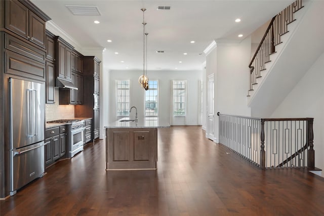 3622 Lannister Ln, Houston, TX 77055 - kitchen featuring high quality appliances, a sink, dark wood-style flooring, recessed lighting, and ornamental molding