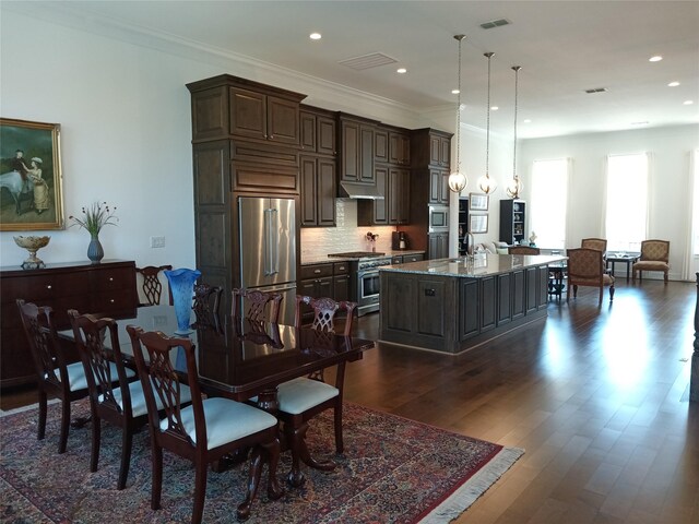3622 Lannister Ln, Houston, TX 77055 - dining area featuring dark wood-style floors, recessed lighting, and ornamental molding