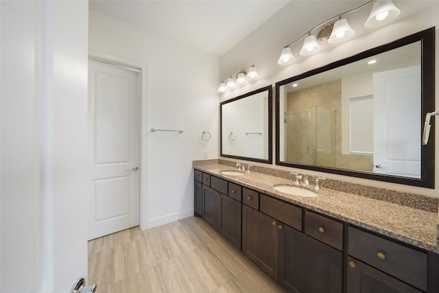 3622 Lannister Ln, Houston, TX 77055 - bathroom with a stall shower, double vanity, and baseboards