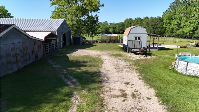15402 Maple St, Santa Fe, TX 77517 - view of grassy yard with an outbuilding and an outdoor pool