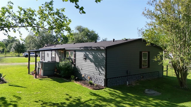 15402 Maple St, Santa Fe, TX 77517 - view of side of home with a lawn