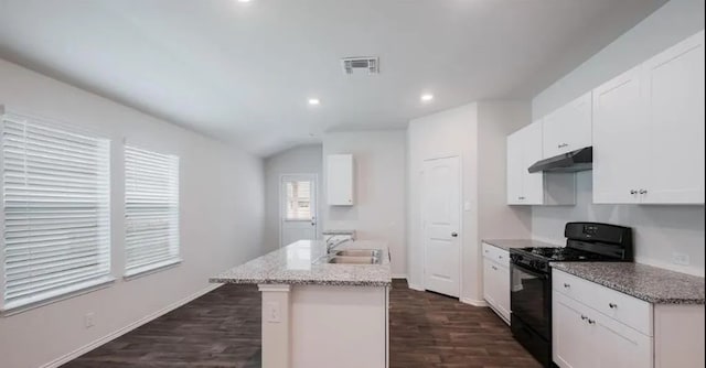 12803 Heddington Grove Ln, Houston, TX 77047 - kitchen featuring gas stove, under cabinet range hood, a sink, a kitchen island with sink, and dark wood-style floors