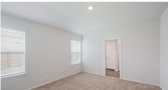 12803 Heddington Grove Ln, Houston, TX 77047 - unfurnished room with light carpet, baseboards, vaulted ceiling, and recessed lighting