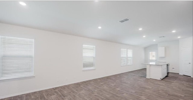 12803 Heddington Grove Ln, Houston, TX 77047 - unfurnished living room with wood finished floors, recessed lighting, lofted ceiling, and baseboards