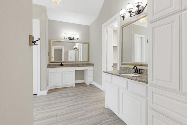 28116 Chuckwagon Trl, Magnolia, TX 77355 - bathroom featuring a chandelier, baseboards, and two vanities