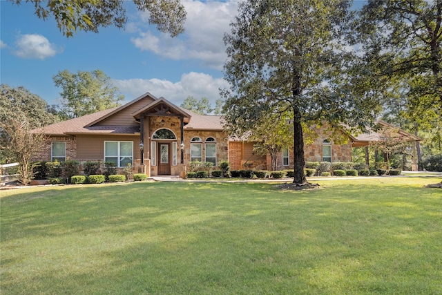 28116 Chuckwagon Trl, Magnolia, TX 77355 - ranch-style house featuring a front yard and stone siding
