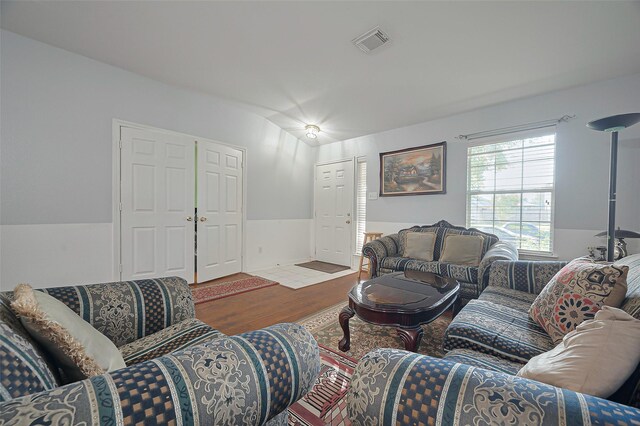 living room with wood finished floors and lofted ceiling