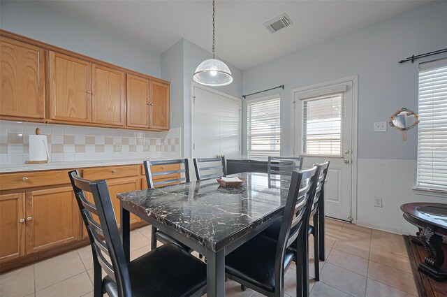 dining area with light tile patterned floors and plenty of natural light