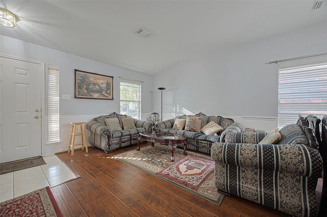 living area featuring lofted ceiling and wood finished floors