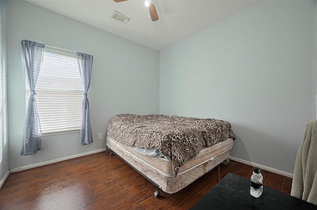 bedroom with baseboards and hardwood / wood-style floors