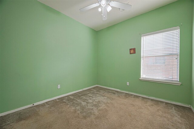 unfurnished room with healthy amount of natural light, ceiling fan, carpet, and baseboards