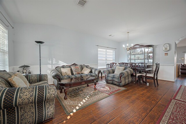 living room featuring a chandelier and hardwood / wood-style floors