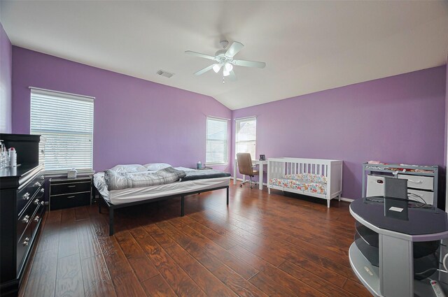 bedroom featuring lofted ceiling, dark wood-style floors, and a ceiling fan