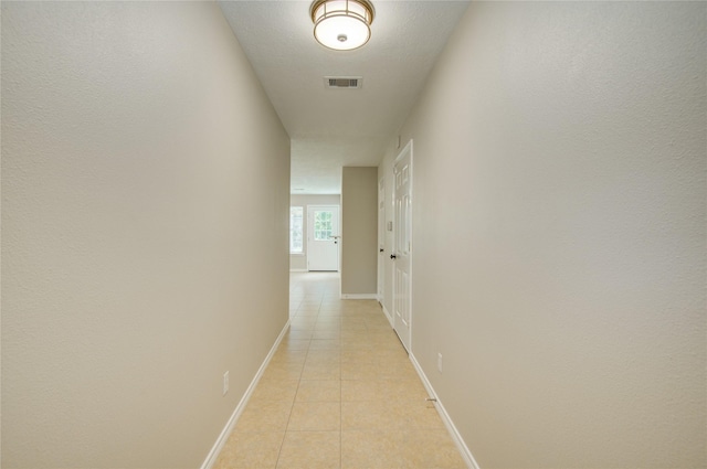 9024 Zapata Way, Willis, TX 77378 - hallway featuring light tile patterned floors and baseboards