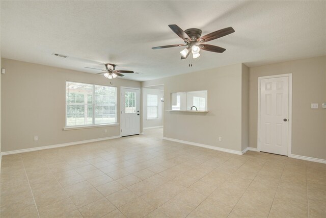 9024 Zapata Way, Willis, TX 77378 - unfurnished room featuring ceiling fan, baseboards, light tile patterned floors, and a textured ceiling