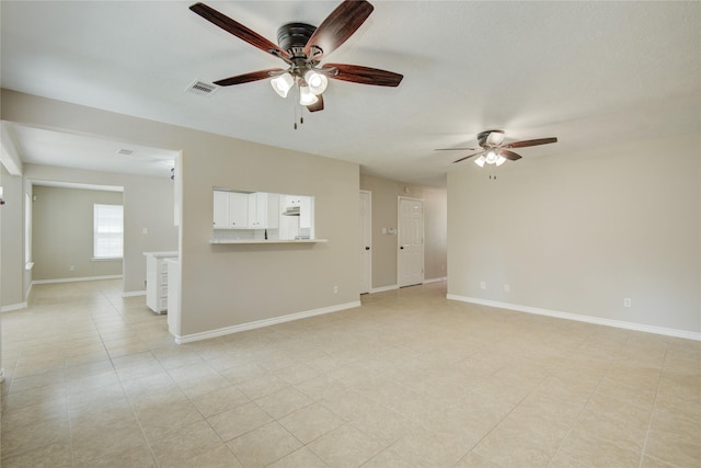 9024 Zapata Way, Willis, TX 77378 - unfurnished living room featuring a ceiling fan and baseboards