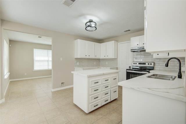 9024 Zapata Way, Willis, TX 77378 - kitchen with stainless steel electric range oven, a sink, decorative backsplash, light stone counters, and baseboards