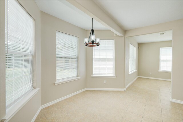 9024 Zapata Way, Willis, TX 77378 - spare room with a chandelier, light tile patterned floors, and baseboards