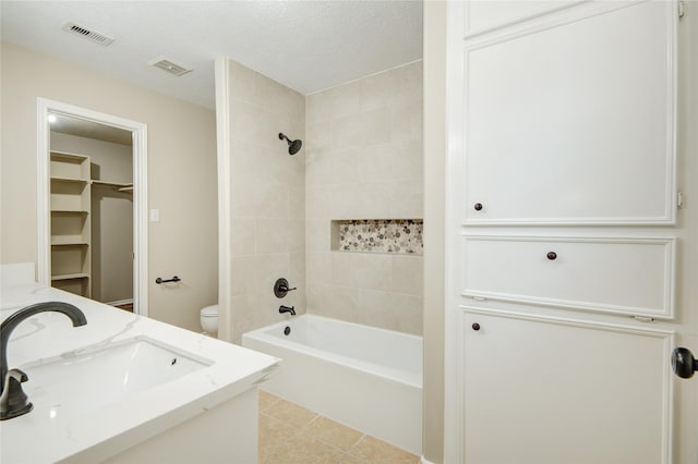 9024 Zapata Way, Willis, TX 77378 - bathroom with toilet, vanity, a walk in closet, tub / shower combination, and tile patterned flooring