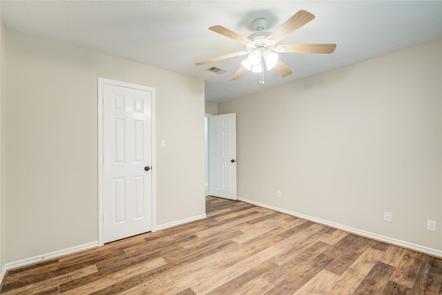 9024 Zapata Way, Willis, TX 77378 - spare room featuring wood finished floors, baseboards, and a ceiling fan