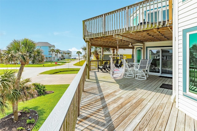wooden deck with a yard and a residential view