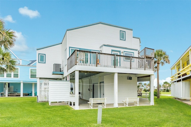 rear view of property with a lawn and a wooden deck