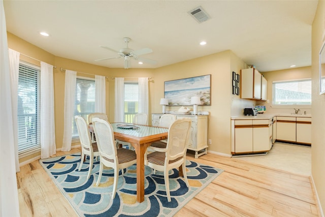 dining space featuring light wood-style floors, baseboards, ceiling fan, and recessed lighting